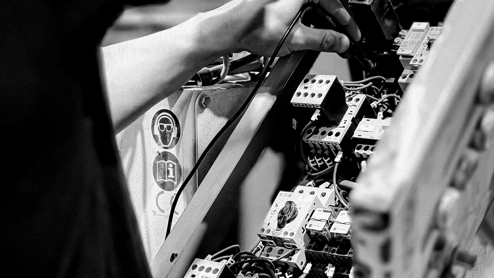 Technician working on an electrical control panel